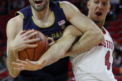 Notre Dame's John Mooney grabs a rebound over N.C. State's Jericole Hellemes during the first half on Wednesday, Jan. 8, at PNC Arena in Raleigh, N.C. NCST defeated ND 73-68.