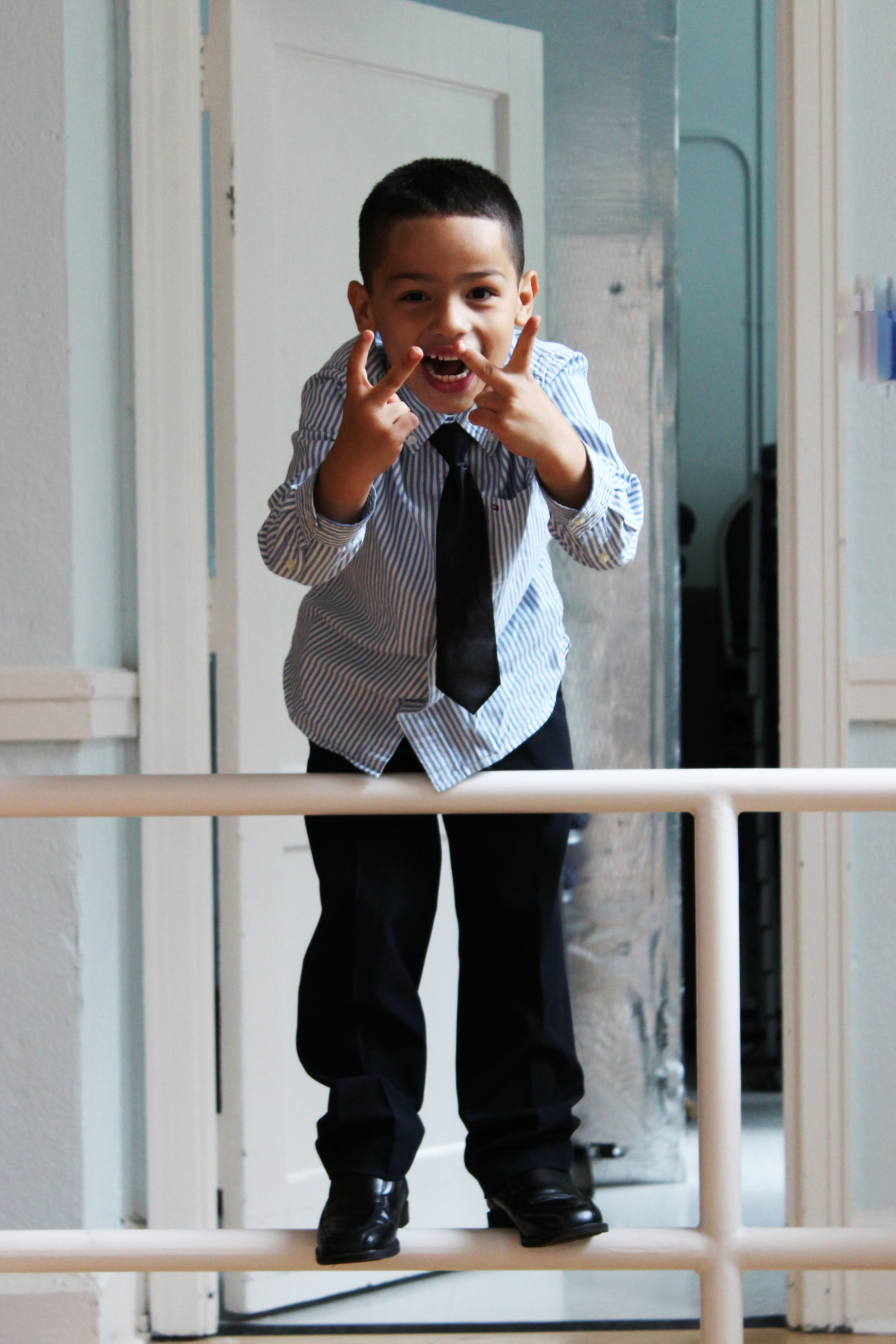 boy-with-tie-on-railing