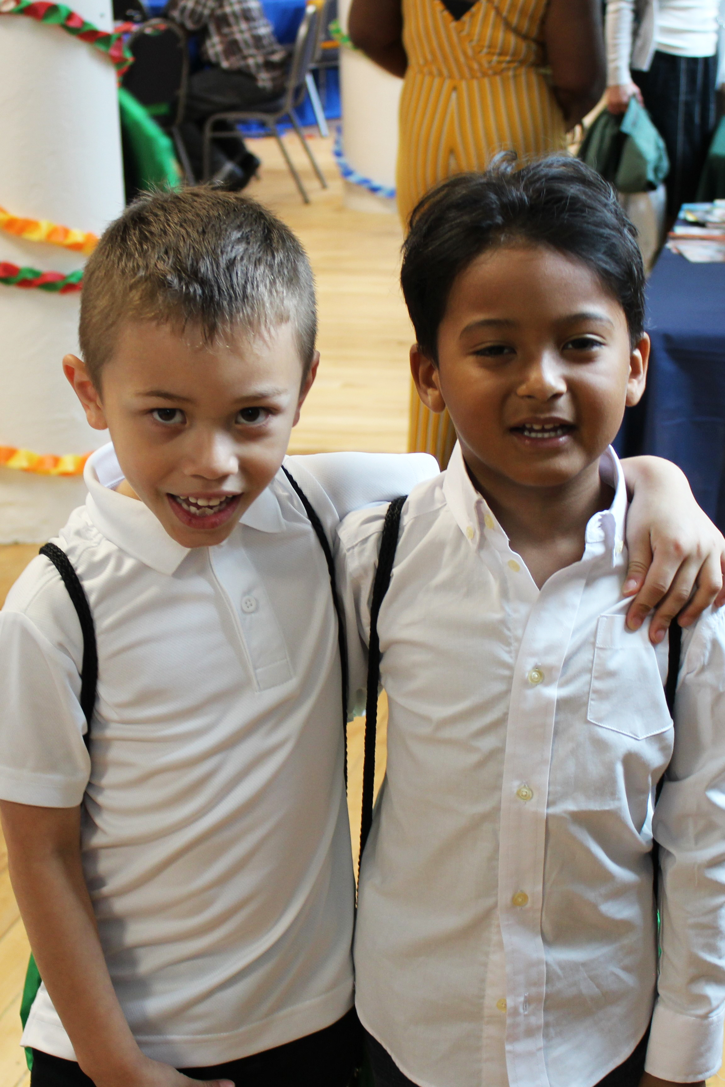 two-boys-with-white-dress-shirts-and-backpacks-on