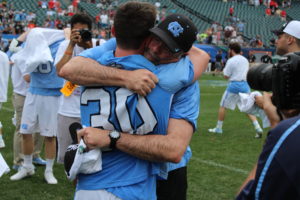 Coach Joe Breschi hugs his goalie Brian Balkum after winning the national championship