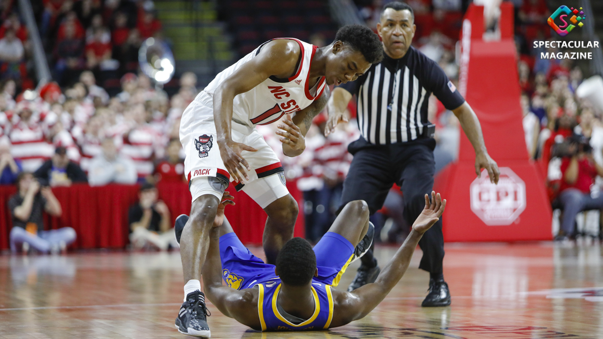 N.C. State senior guard Markell Johnson (11) stands over Pittsburgh sophomore guard Xavier Johnson durng the second half at PNC Arena in Raleigh, N.C., Saturday, Feb. 29, 2020. NCSU defeated Pitt 77-73. NC State severed ties with CPI Security after racist remarks by CEO Kenneth Gill.