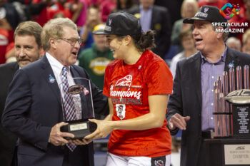 ACC Comissioner John Swofford hands NC State guard Aislinn Konig the 2020 ACC Women’s Basketball Tournament Most Valuable Player after they defeated Florida State 71-66 in the championship at the Greensboro Coliseum in Greensboro, N.C., Sunday, Mar. 8, 2020. Photo © Landon Bost