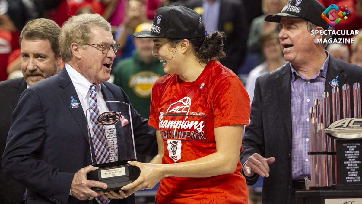 ACC Commissioner John Swofford hands NC State guard Aislinn Konig the 2020 ACC Women’s Basketball Tournament Most Valuable Player after they defeated Florida State 71-66 in the championship at the Greensboro Coliseum in Greensboro, N.C., Sunday, Mar. 8, 2020. Photo © Landon Bost