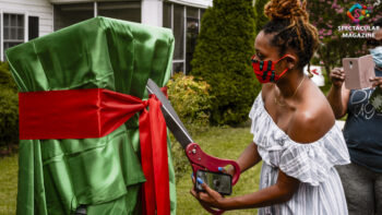 Wall Street Juniors community coordinator Mary Jane McCain cuts the ribbon wrapped around the WSJ Reader's Bank in Old North Durham, N.C., Saturday, Aug. 1. Photo submitted by MaKayla Booker. Photo © TNT Portraits 2020.