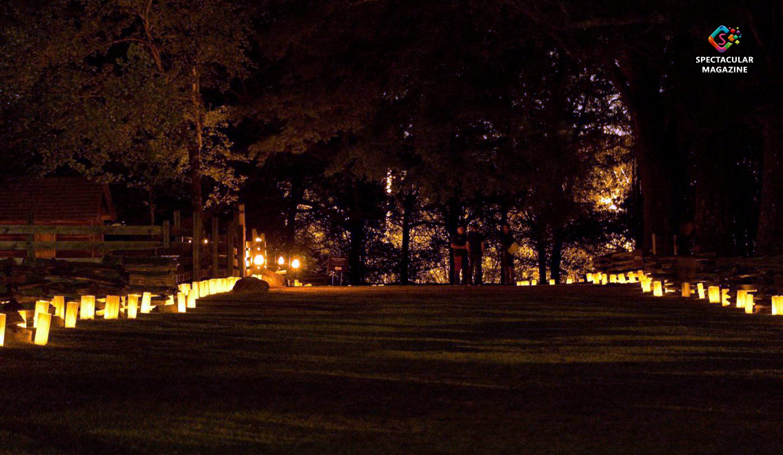 Rows of glowing luminaries light up a grassy path at Bennett Place State Historic Site in Durham during a nighttime event commemorating enslaved people’s journeys to freedom in North Carolina.