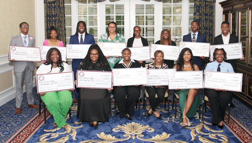 2025 Perry Scholarship Fund awardees proudly display mock $2,000 scholarship checks during the Legacy Luncheon.