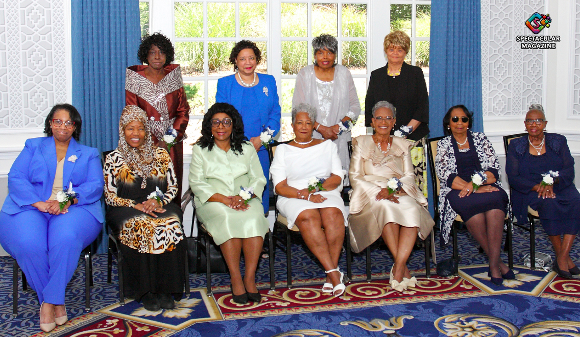 2025 Legacy Luncheon honorees, standing and seated, celebrated for their service as administrative and clerical assistants for faith-based organizations.