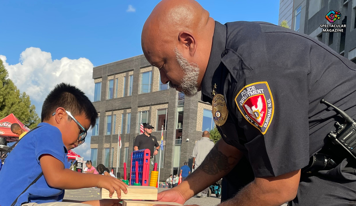 Durham Police officers greeting families and neighbors during a past National Night Out event, promoting community safety and crime prevention partnerships.