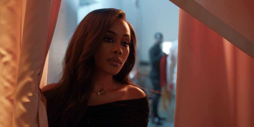 Shannon Thornton as Joy peers through backstage curtains in Tyler Perry’s Finding Joy (Prime Video).