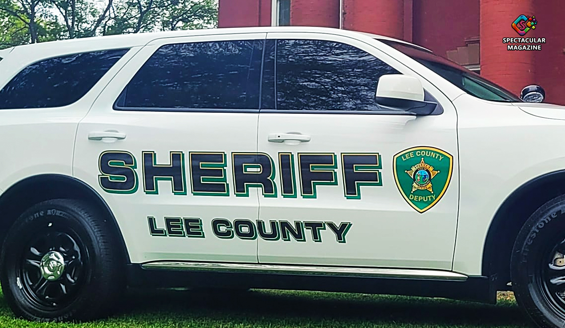 Photo of Lee County Sheriff’s Office vehicle parked near wooded area where suspect was found.