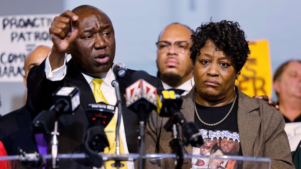 Civil rights attorney Ben Crump stands beside Sonya Williams, the mother of Darryl Williams, as she weeps during a press conference at Mount Peace Baptist Church in Raleigh.
