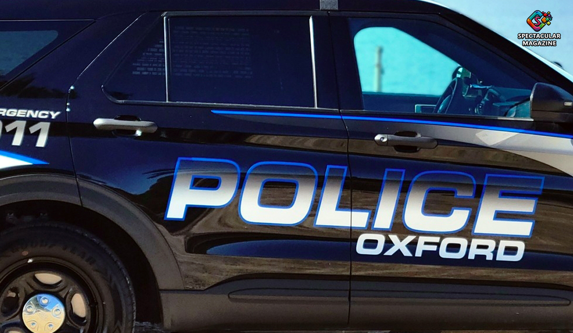 Oxford Police Department patrol car with flashing lights during a crime scene investigation of a 48-year-old man's shooting.