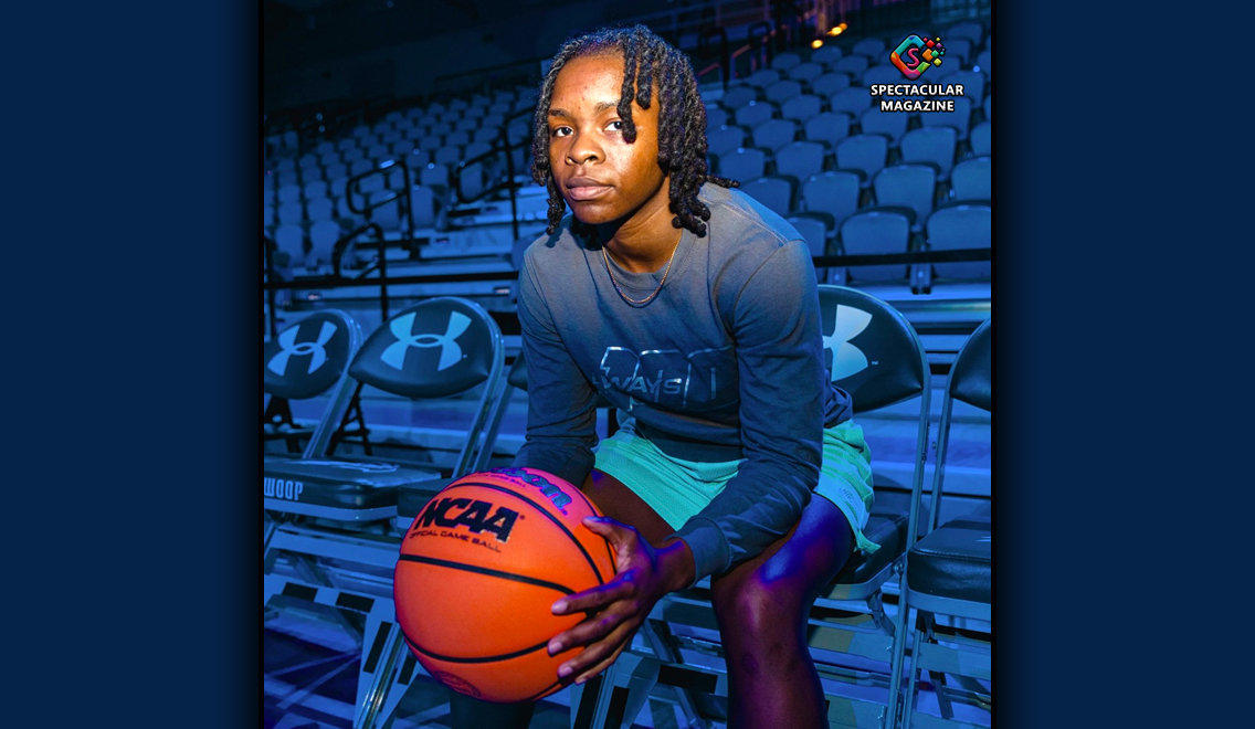 Female basketball player seated in arena holding NCAA basketball, representing professional tryouts with The UPSHOT League.