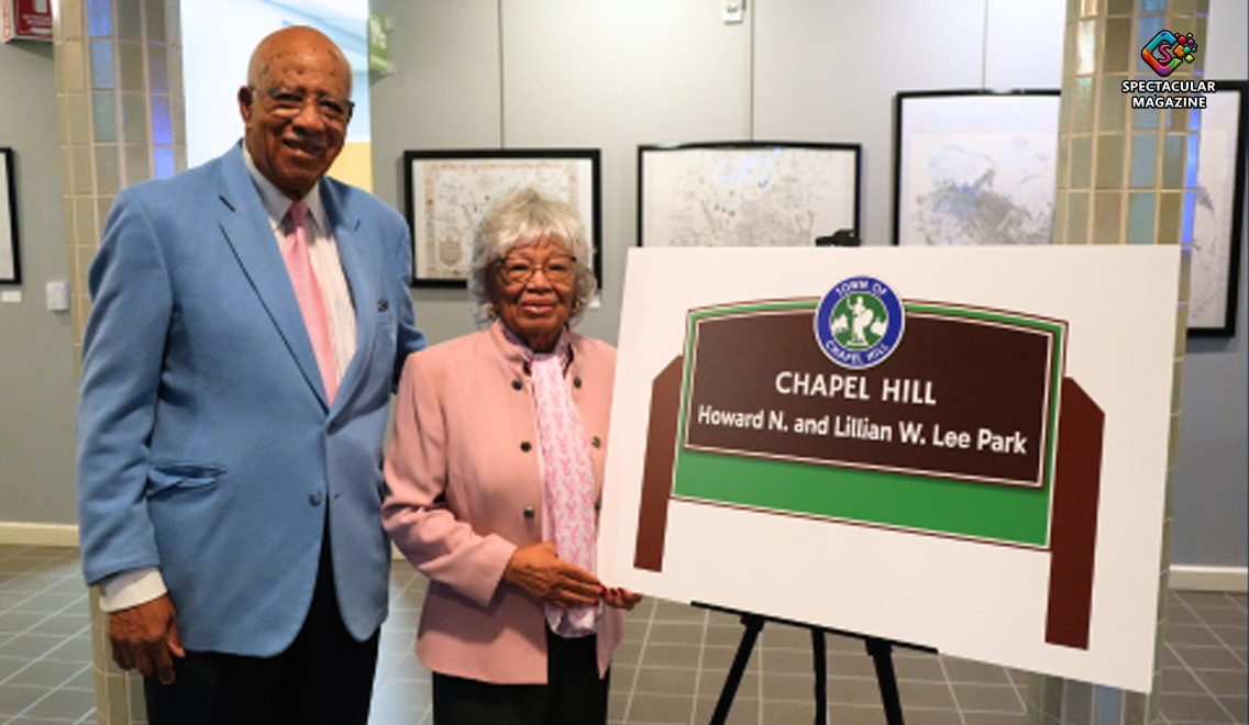 Howard and Lillian Lee beside a conceptual sign announcing the future Chapel Hill park and street named in their honor.