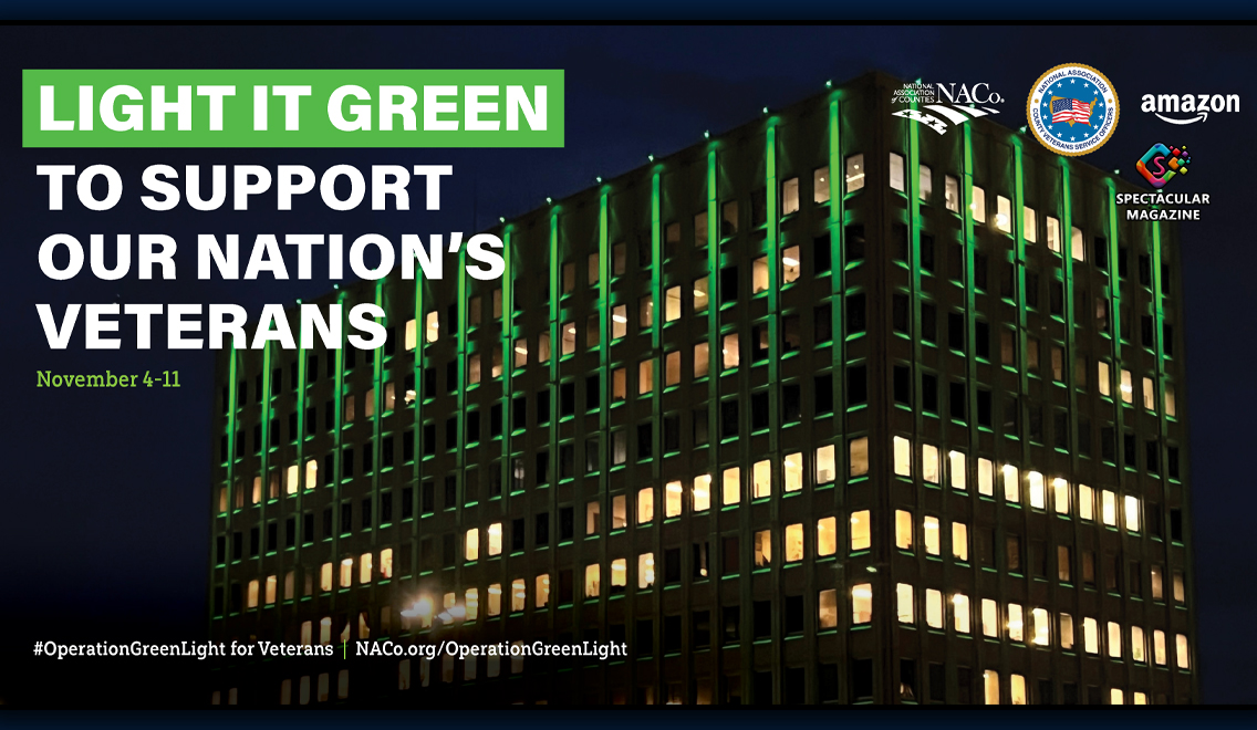 Operation Green Light for Veterans campaign graphic showing a multistory building illuminated green at night, with NACo and partner logos.