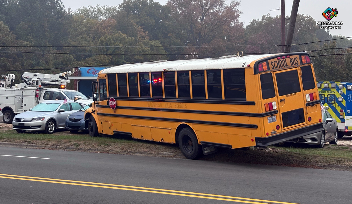 School bus that crashed onto the property of LC Auto Sales on Holloway Street in Durham, damaging vehicles and bringing down communication lines.